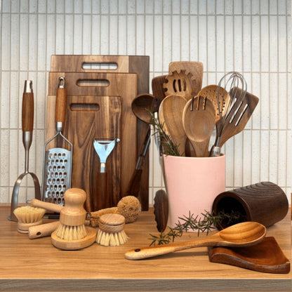 Collection of kitchen utensils and tools on a wooden surface with text 'The Whole Kitchen Reset Bundle'.