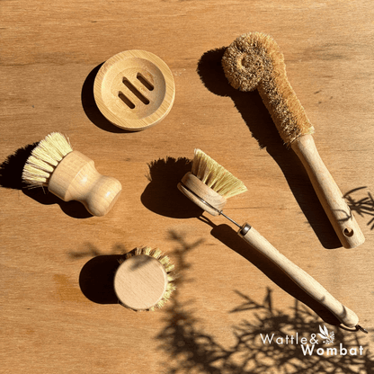 Set of wooden cleaning brushes and a soap dish on a wooden surface with 'Waffle & Wombat' branding.